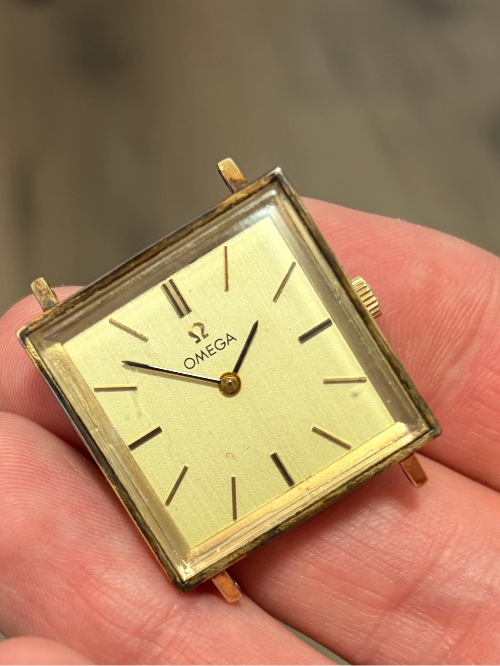 vintage square gold Omega dress watch, closely resembling mid-1960s manual-wind